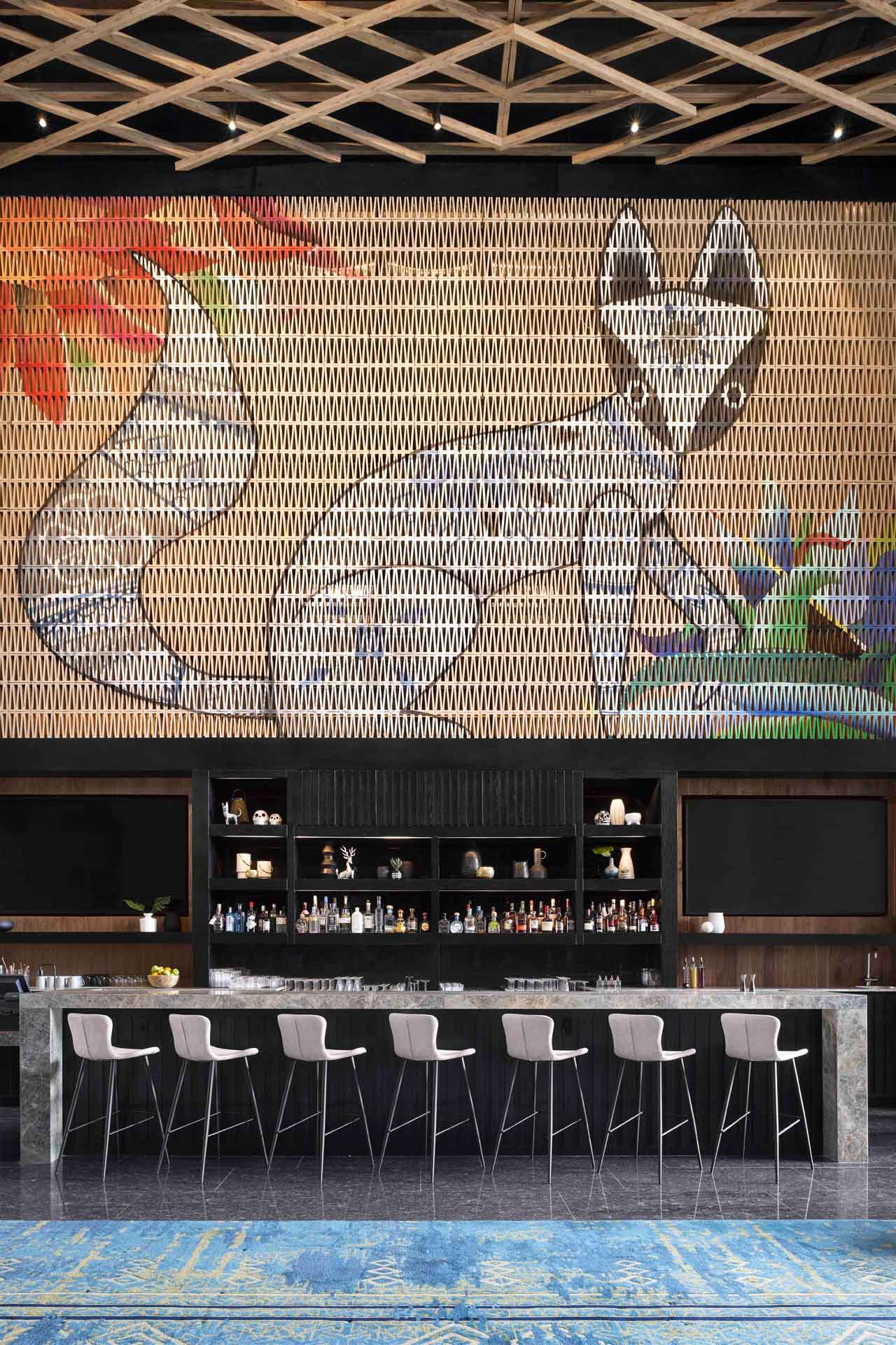 A mural by local artists hangs over the granite bar